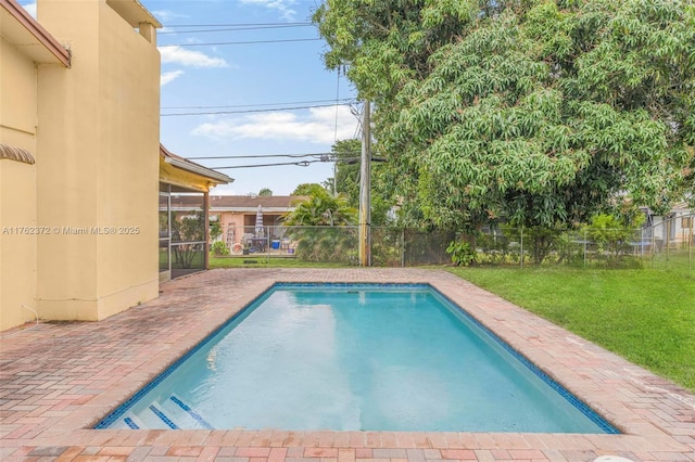 view of pool featuring a patio area, a lawn, a fenced backyard, and a fenced in pool