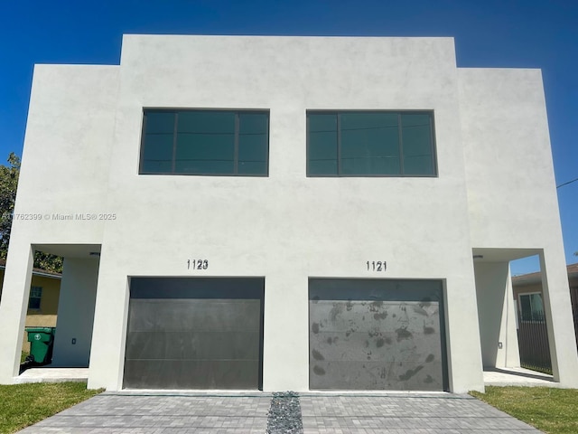 modern home with stucco siding and a garage