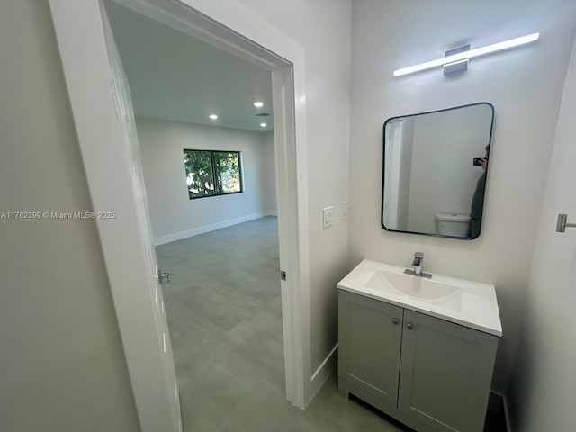 bathroom featuring recessed lighting, baseboards, and vanity