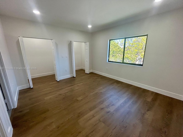 unfurnished bedroom featuring recessed lighting, baseboards, and wood finished floors