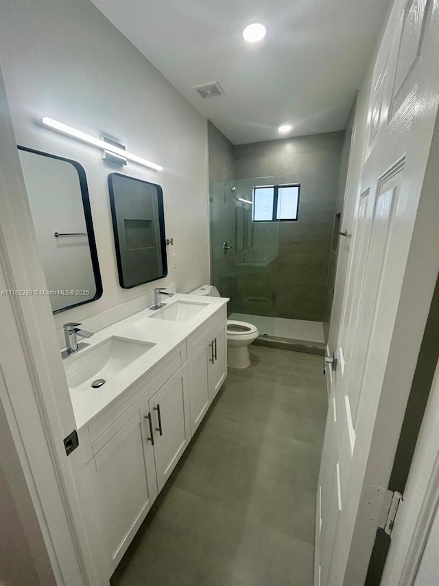 bathroom with a sink, visible vents, toilet, and a stall shower