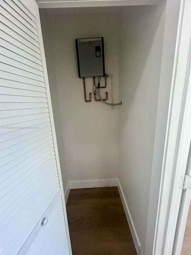 interior space with baseboards and dark wood-type flooring