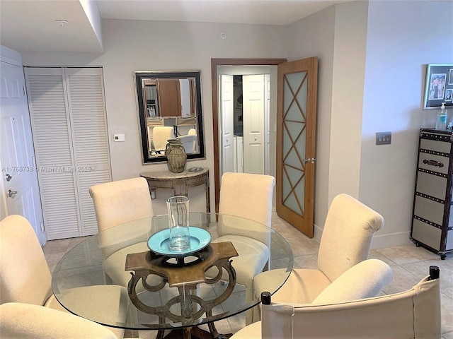 dining room with light tile patterned floors and baseboards