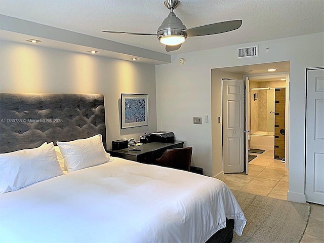 bedroom featuring light tile patterned floors, a textured ceiling, ensuite bath, and ceiling fan