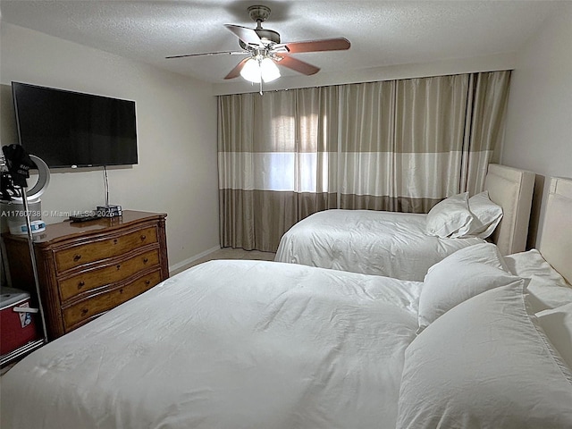 bedroom with a textured ceiling and a ceiling fan