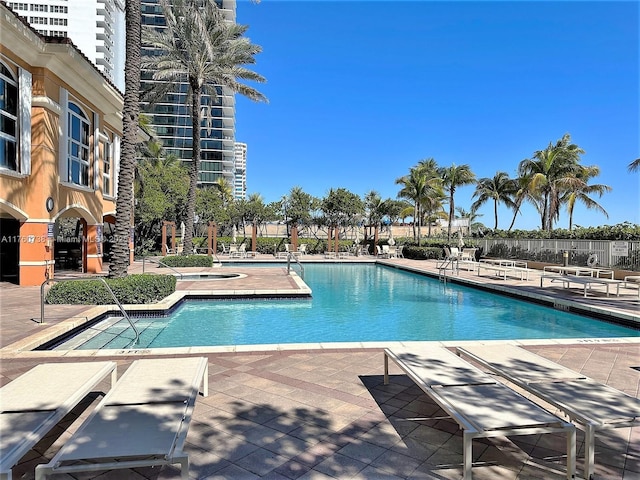 pool featuring a patio and fence