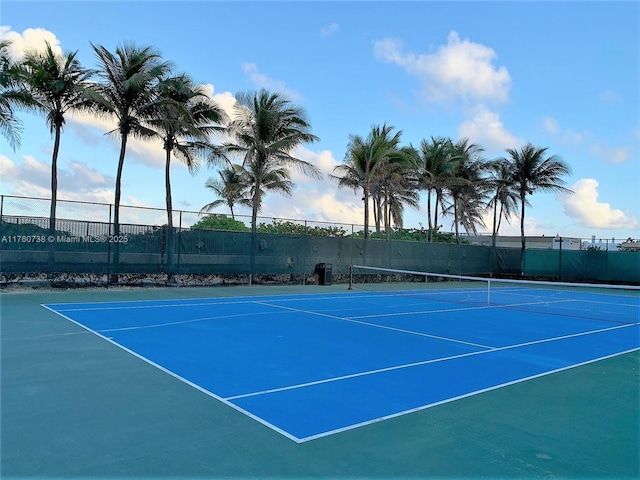 view of tennis court featuring fence