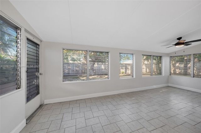 unfurnished sunroom featuring vaulted ceiling and a ceiling fan