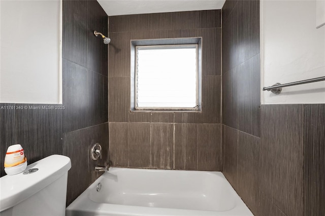 full bath with tile walls, toilet, and washtub / shower combination