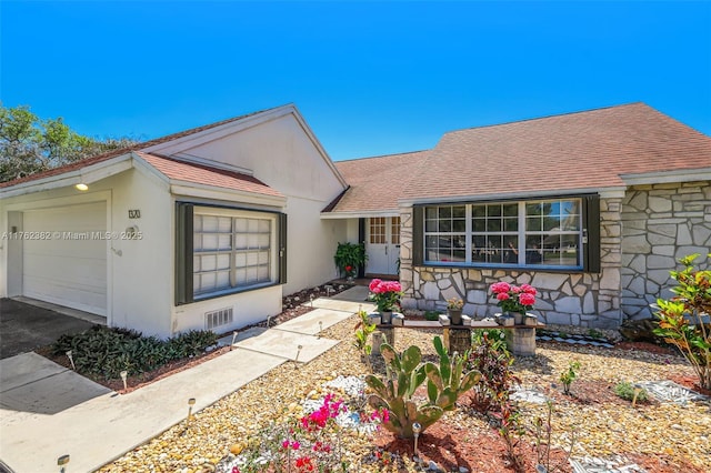 single story home featuring stone siding, stucco siding, an attached garage, and a shingled roof