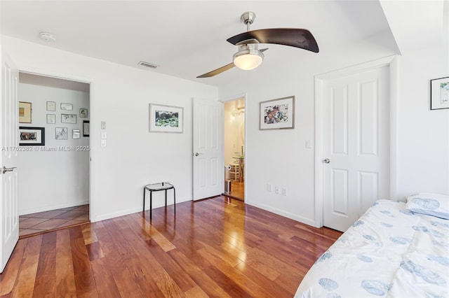 bedroom featuring hardwood / wood-style floors, baseboards, and visible vents