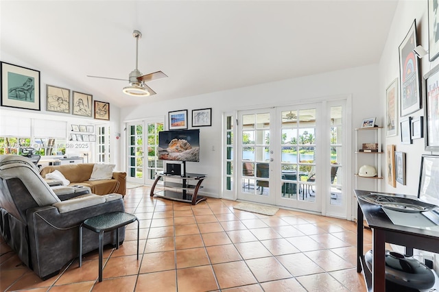 tiled living room with vaulted ceiling, french doors, and ceiling fan