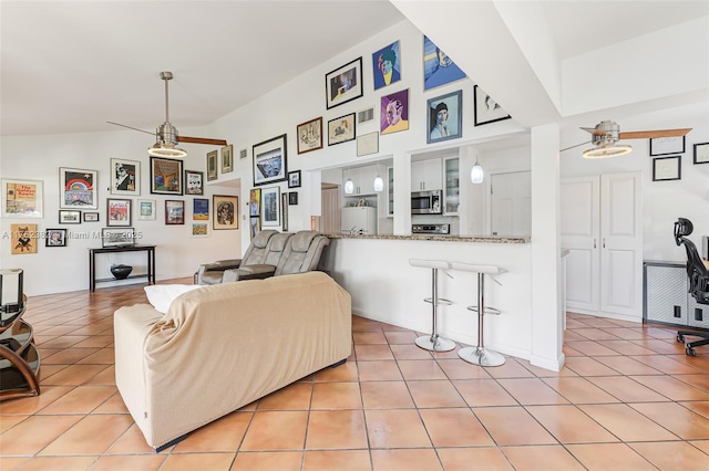 living room with vaulted ceiling and light tile patterned floors