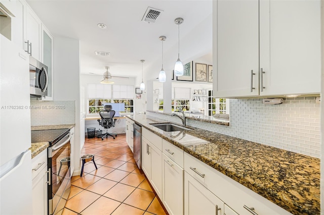 kitchen with visible vents, light tile patterned flooring, a sink, appliances with stainless steel finishes, and white cabinetry