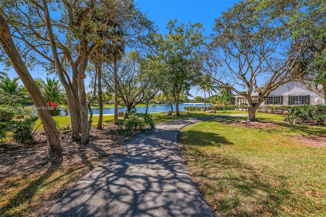 view of community with a lawn and a water view