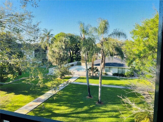 view of property's community with a yard