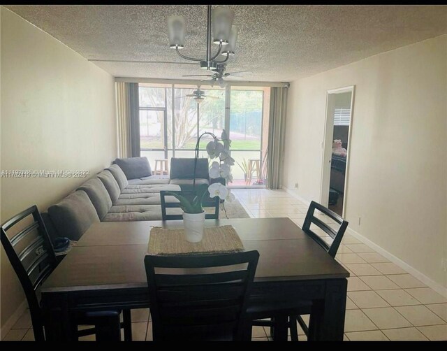 dining space featuring light tile patterned floors, baseboards, a textured ceiling, and ceiling fan