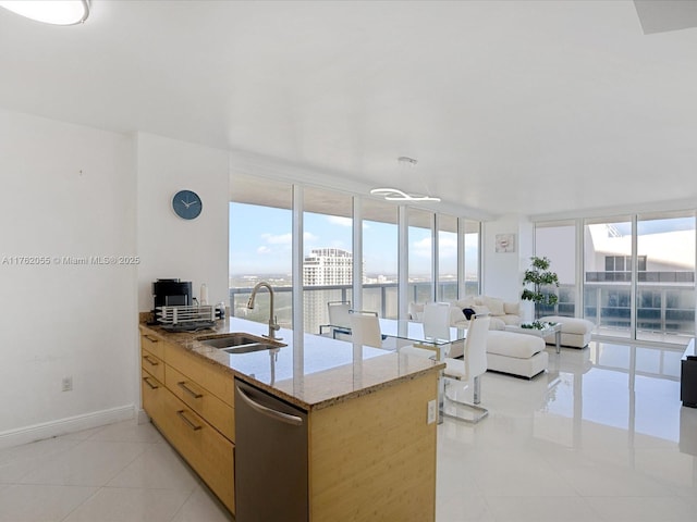 kitchen featuring plenty of natural light, floor to ceiling windows, dishwasher, and a sink