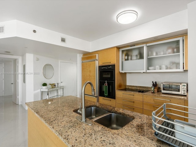 kitchen featuring a sink, glass insert cabinets, a toaster, visible vents, and black appliances