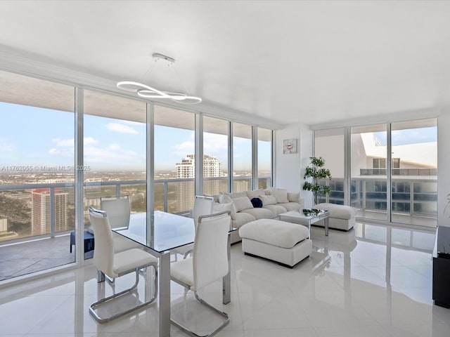 sunroom / solarium featuring an inviting chandelier, a city view, and plenty of natural light