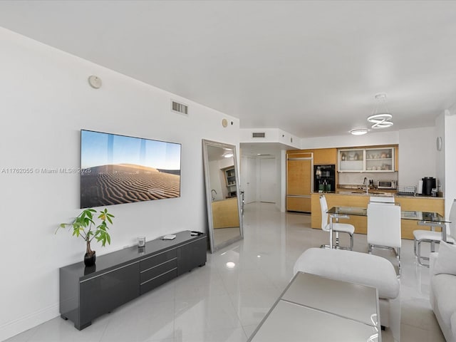 living area with a toaster, baseboards, and visible vents