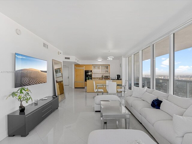 living room featuring visible vents and light tile patterned floors