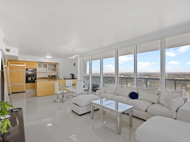 living room with a wall of windows and visible vents