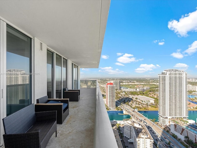 balcony with a water view and a city view