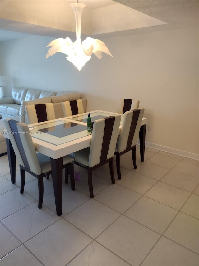 dining room with light tile patterned floors and baseboards