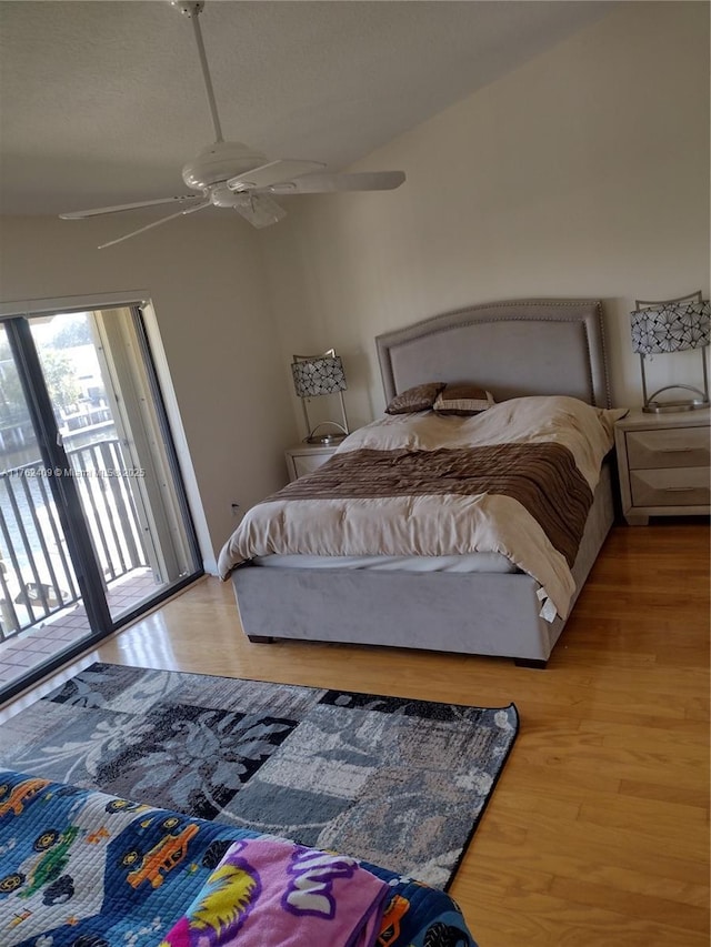 bedroom with wood finished floors, a ceiling fan, and access to outside