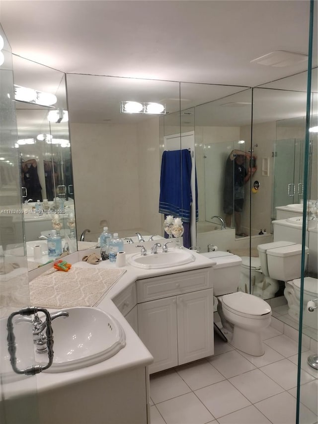 full bathroom with tile patterned flooring, toilet, vanity, and a shower with door