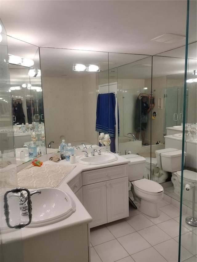 full bath with tile patterned flooring, toilet, vanity, and a shower with door