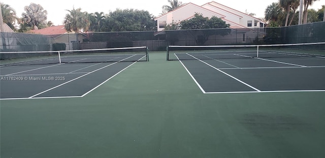 view of tennis court with fence