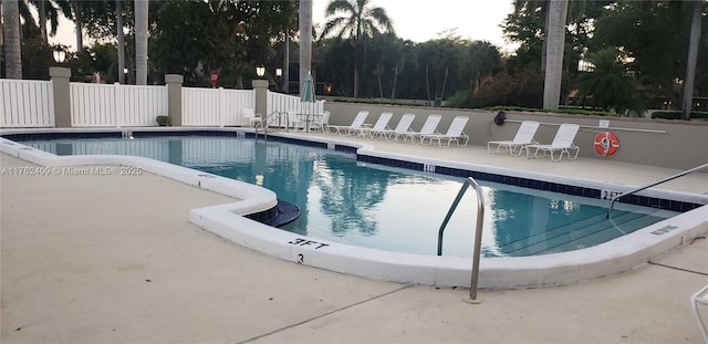 pool featuring a patio and fence