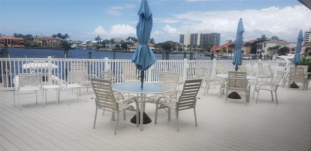 240 Captains Walk Unit 5140, Delray Beach, FL 33483 - wooden terrace with outdoor dining area and a water view
