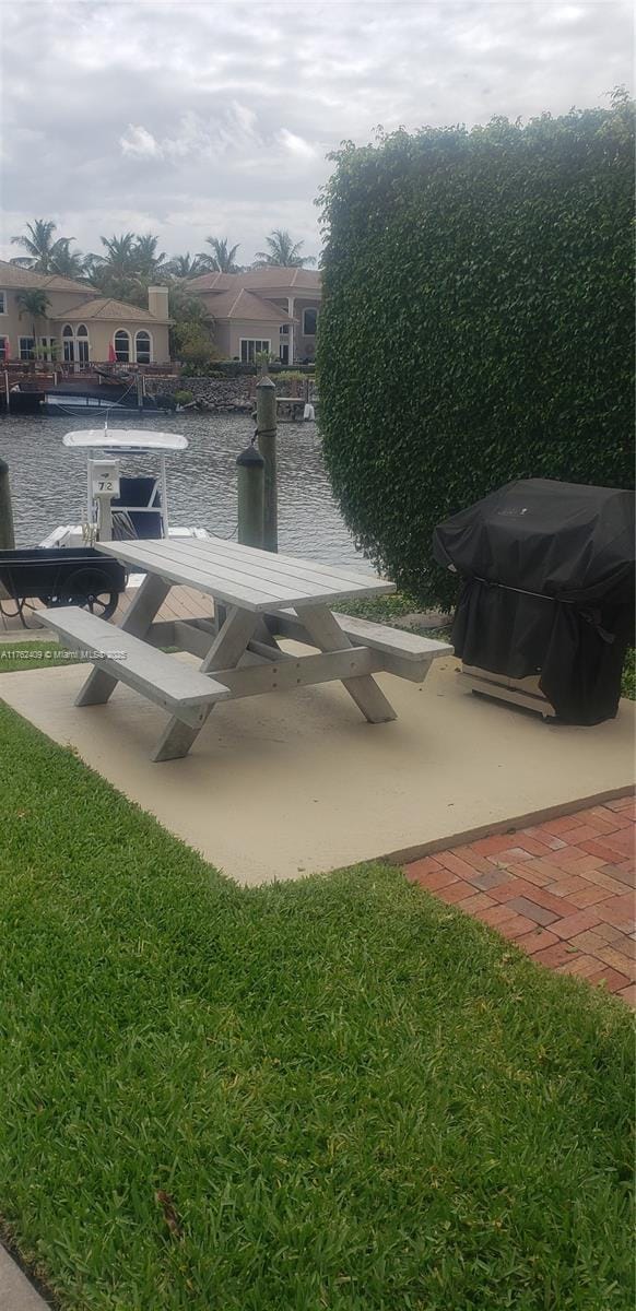 exterior space with a water view and a dock