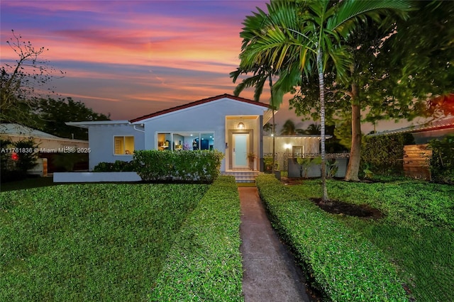 view of front of property featuring a front yard and stucco siding