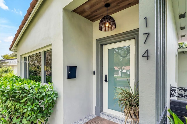 property entrance with stucco siding