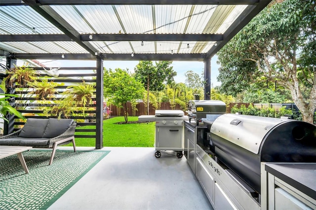 view of patio with grilling area, fence private yard, and exterior kitchen