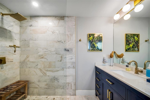 bathroom featuring baseboards, walk in shower, and vanity