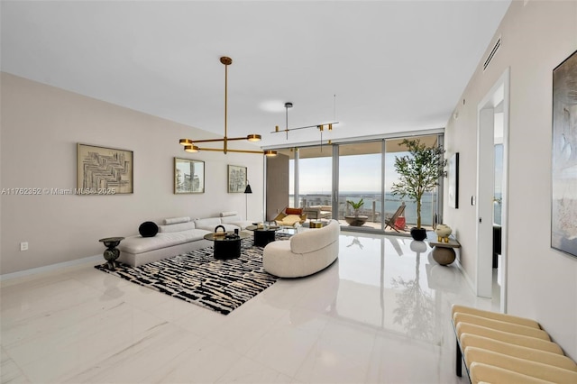 living area with a notable chandelier, a wall of windows, and baseboards