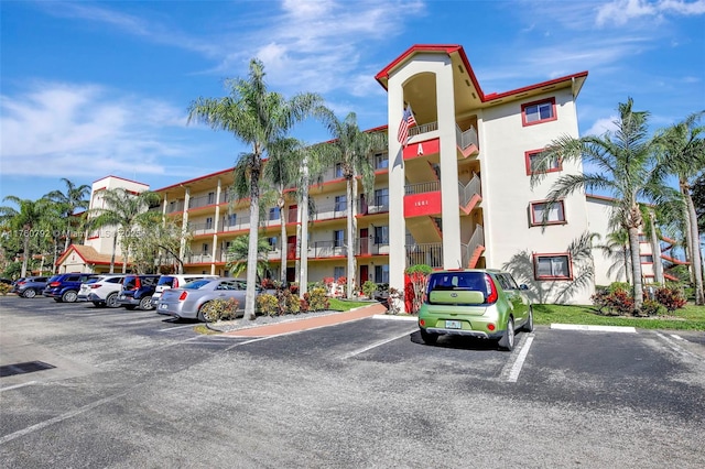 view of building exterior featuring uncovered parking