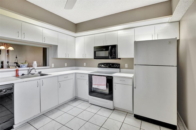 kitchen with a sink, black appliances, white cabinets, and light countertops