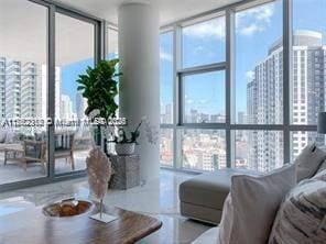 living area featuring a view of city and floor to ceiling windows