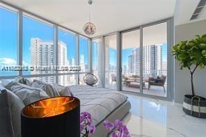 bedroom featuring floor to ceiling windows, a view of city, and access to outside