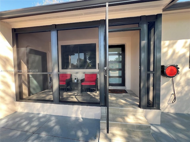 property entrance featuring stucco siding