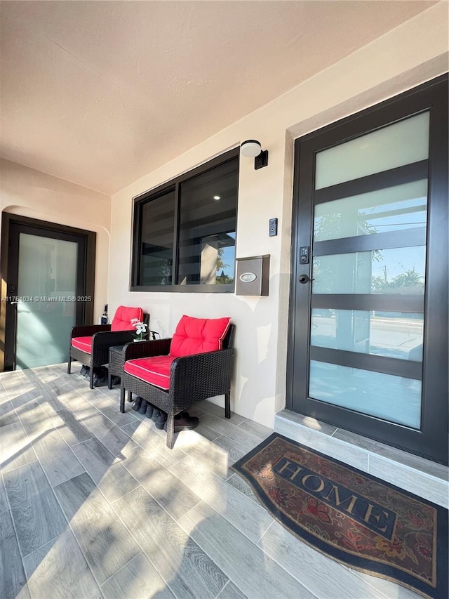 doorway to property featuring stucco siding