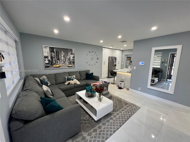 living room with recessed lighting, visible vents, baseboards, and marble finish floor