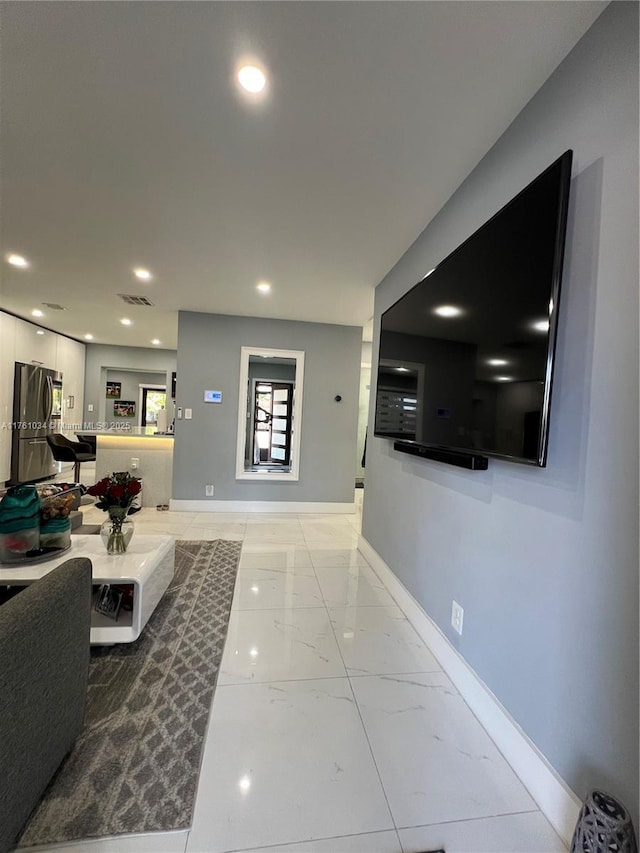 interior space with recessed lighting, marble finish floor, visible vents, and baseboards