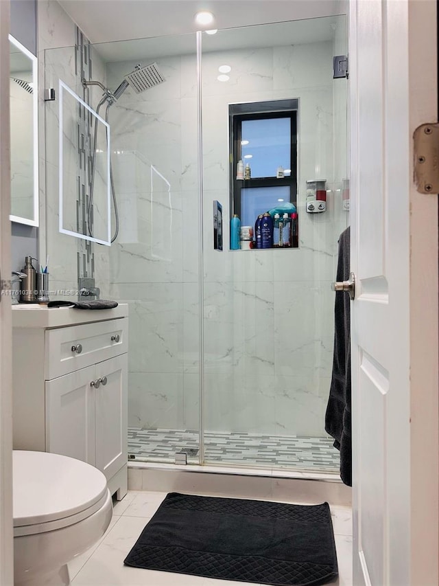 full bath with vanity, toilet, marble finish floor, and a marble finish shower